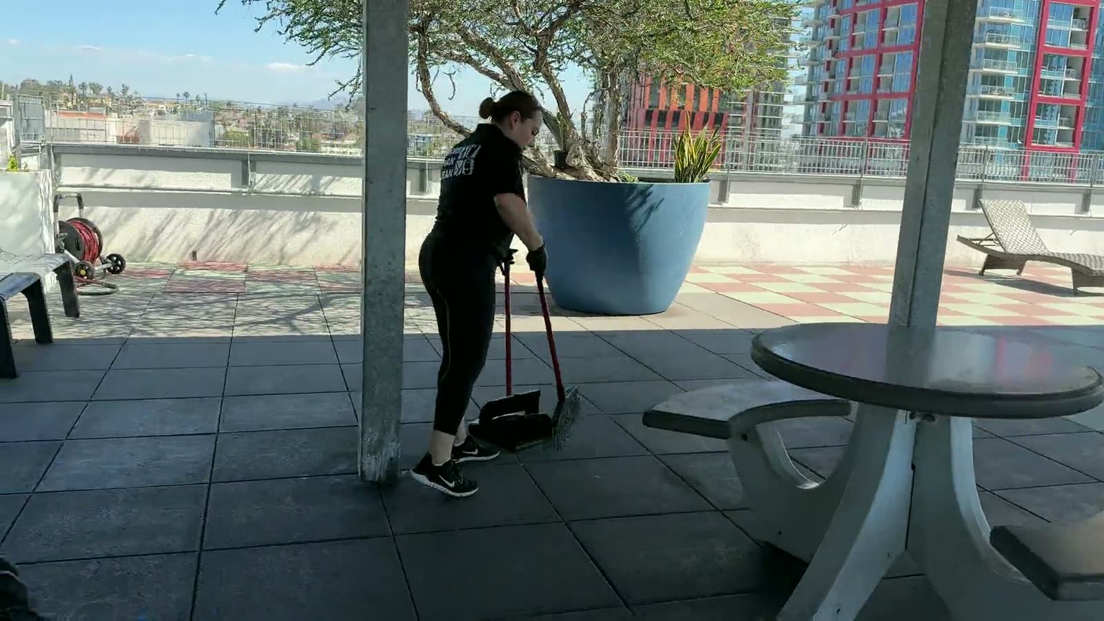 A cleaner wiping down a shared conference table